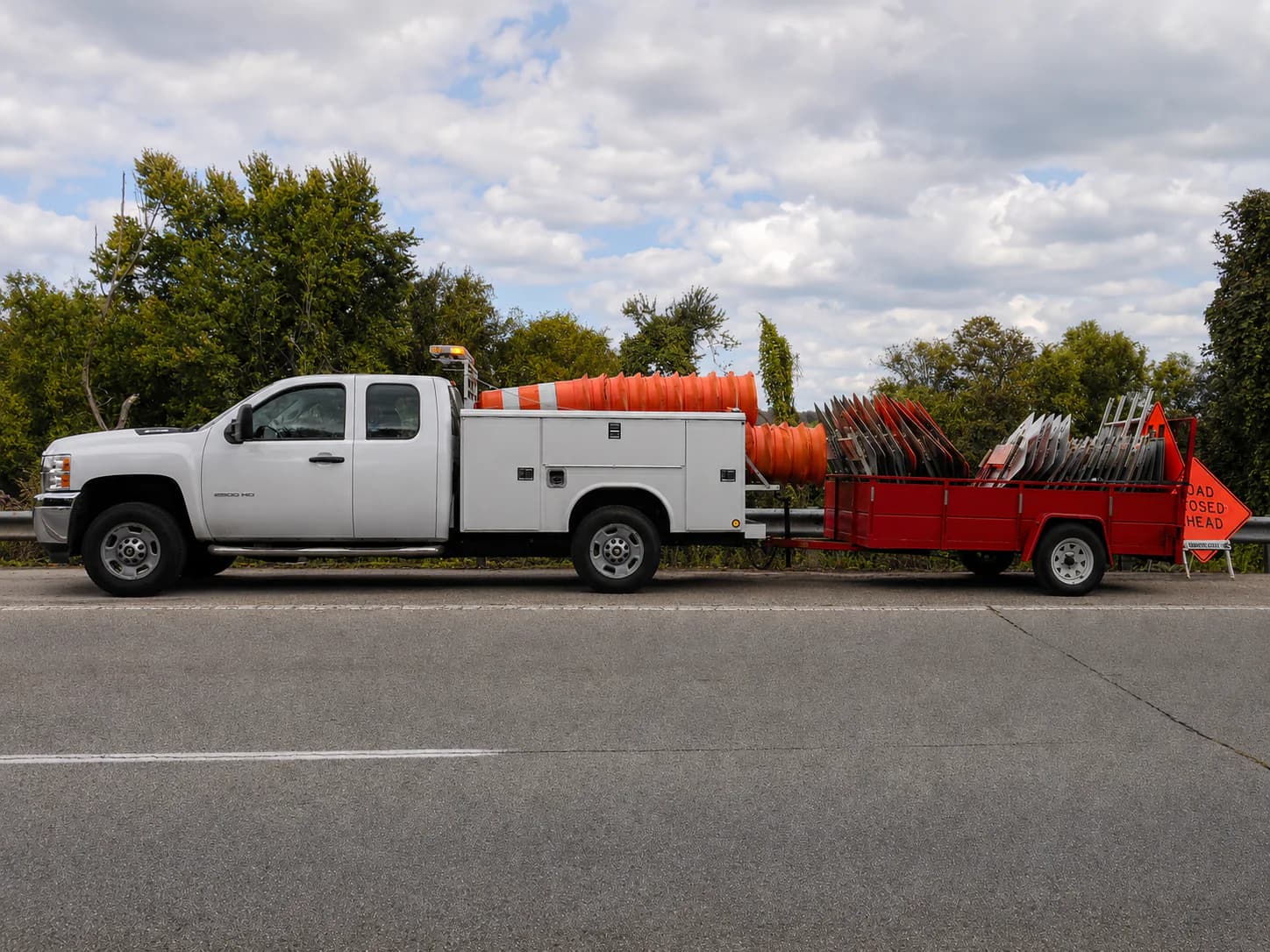 The A-1 Barricades truck and equipment trailer loaded with drums and barricades